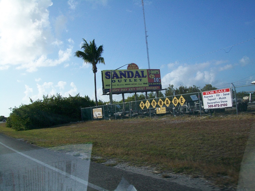 sign advertising Sandal Outlet, with the tag line Why Pay Key West Prices?